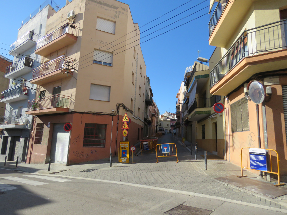 Torrent de la Pólvora amb cartell d'obres en primer pla i a l'esquerra, cartell avisant que el carrer queda en cul-de-sacg
